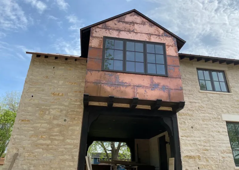 Copper metal panel facade on a stone building for Skylight Installation in Stonecrest