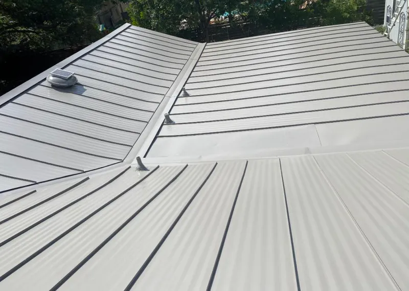Solar attic fan installed on a metal roof for Roof Ventilation in Stonecrest